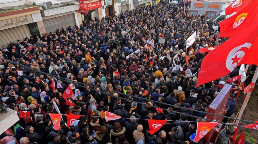 Tunisians demonstrating on revolution anniversary