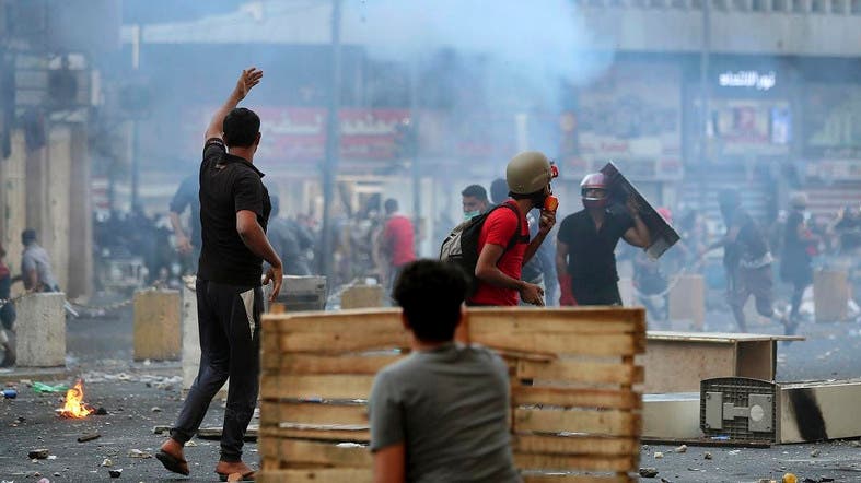 Iraqi forces push protesters back to main square, kill five